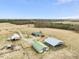 Aerial view of a large farm with multiple barns and a single-Gathering home at 9550 Silk Hope Liberty Rd, Siler City, NC 27344