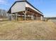 Open sided barn with a metal roof and wooden support beams at 9550 Silk Hope Liberty Rd, Siler City, NC 27344