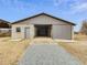 Exterior view of the large barn, featuring a metal exterior, concrete floor and sliding door at 9550 Silk Hope Liberty Rd, Siler City, NC 27344