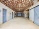 Spacious barn interior featuring multiple stalls, concrete flooring, and an open ceiling at 9550 Silk Hope Liberty Rd, Siler City, NC 27344