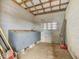 Inside a barn stall showing concrete flooring, cinder block construction and open ceiling at 9550 Silk Hope Liberty Rd, Siler City, NC 27344