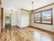 Dining room with hardwood floors, trim detail, and a view out a large window at 9550 Silk Hope Liberty Rd, Siler City, NC 27344