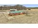 Charming brick home with a green metal roof surrounded by a large grassy yard and fencing at 9550 Silk Hope Liberty Rd, Siler City, NC 27344
