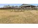 Farm showing large open field with post and plank fence, large barn, and dry grass at 9550 Silk Hope Liberty Rd, Siler City, NC 27344