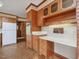 Kitchen features wood cabinets, an island with eat-in bar, and built in workspace at 9550 Silk Hope Liberty Rd, Siler City, NC 27344