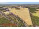 The expansive land parcel includes a mix of open field and woods with approximate boundaries outlined at 9550 Silk Hope Liberty Rd, Siler City, NC 27344