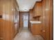 Mud room featuring paneled walls, tile floors, and a bright exit door at 9550 Silk Hope Liberty Rd, Siler City, NC 27344