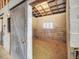 Inside of a barn stall showing the cinder block construction and half open sliding door at 9550 Silk Hope Liberty Rd, Siler City, NC 27344