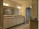 Bright bathroom featuring double vanity, granite countertops, and a glass enclosed walk-in shower at 10420 Sablewood Drive Dr # 102, Raleigh, NC 27617