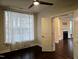 Bedroom with ceiling fan, light-filled windows with sheer curtains, and hardwood floors at 10420 Sablewood Drive Dr # 102, Raleigh, NC 27617