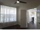 Bedroom with modern ceiling fan, large windows with curtains, and hardwood floors at 10420 Sablewood Drive Dr # 102, Raleigh, NC 27617
