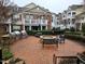 Brick paved outdoor grilling and entertainment area with multiple grills and fire pit at 10420 Sablewood Drive Dr # 102, Raleigh, NC 27617