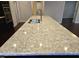 Close up of an island with a speckled granite countertop and stainless steel faucet at 10420 Sablewood Drive Dr # 102, Raleigh, NC 27617