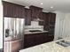 Kitchen area with stainless steel appliances and a kitchen island with granite counters at 10420 Sablewood Drive Dr # 102, Raleigh, NC 27617