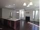 Inviting living room featuring hardwood floors, a fireplace, an open layout, and a large window at 10420 Sablewood Drive Dr # 102, Raleigh, NC 27617