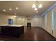 Open floor plan with fireplace, hardwood floors, and a kitchen island at 10420 Sablewood Drive Dr # 102, Raleigh, NC 27617