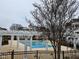 Community pool with pergola and lounge area for relaxing on a cool and overcast day at 10420 Sablewood Drive Dr # 102, Raleigh, NC 27617