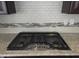 Close up of a gas stove top and white subway tile backsplash at 10420 Sablewood Drive Dr # 102, Raleigh, NC 27617