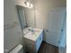 Bathroom vanity featuring white cabinets, a solid surface top, and large mirror at 116 Willow Cameron Way, Angier, NC 27501