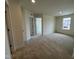 Large carpeted bedroom featuring multiple doorways and windows, providing plenty of natural light and ventilation at 116 Willow Cameron Way, Angier, NC 27501