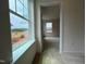 View into a bedroom with neutral carpeting, natural light, offering a serene and comfortable space at 116 Willow Cameron Way, Angier, NC 27501