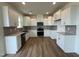 Modern kitchen featuring white cabinets, stainless steel appliances, and subway tile backsplash, designed for culinary enthusiasts at 116 Willow Cameron Way, Angier, NC 27501