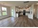 Bright kitchen with stainless steel appliances, white cabinets, and wood-look flooring, offering modern appeal at 116 Willow Cameron Way, Angier, NC 27501