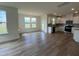 Spacious living room with large windows, wood-look flooring, and natural light, perfect for entertaining at 116 Willow Cameron Way, Angier, NC 27501