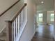 Elegant staircase with wood accents and white railings, leading to the upper level at 116 Willow Cameron Way, Angier, NC 27501