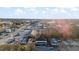 Aerial view showcasing the property with its surrounding neighborhood and distant cityscape at 121 Hamilton St, Henderson, NC 27536