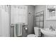 Bright bathroom showcasing a chrome shelf, white toilet, sink, and a window with natural light at 121 Hamilton St, Henderson, NC 27536