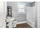 This cozy bathroom features white fixtures, gray walls and hard surface floors at 121 Hamilton St, Henderson, NC 27536