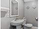 Charming bathroom features pedestal sink and tiled walls at 121 Hamilton St, Henderson, NC 27536