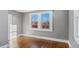 Bedroom with hardwood floors, light gray walls, and a bright window at 121 Hamilton St, Henderson, NC 27536