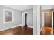 Bedroom featuring hardwood floors, gray walls, white trim and neutral carpet at 121 Hamilton St, Henderson, NC 27536