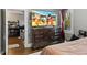 Well-lit bedroom with an entertainment center featuring a flat screen TV and a view of the kitchen at 121 Hamilton St, Henderson, NC 27536