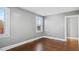 Bedroom featuring hardwood floors, light gray walls, and a bright window at 121 Hamilton St, Henderson, NC 27536