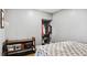 Neutral bedroom featuring closet space, a dark wood storage bench, and a gray paint scheme at 121 Hamilton St, Henderson, NC 27536