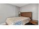 Cozy bedroom featuring a wooden headboard and simple bedside table, illuminated by natural light at 121 Hamilton St, Henderson, NC 27536