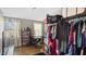 Bright bedroom featuring closet space, a desk, and a rack of hanging clothes at 121 Hamilton St, Henderson, NC 27536