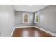 Bright bedroom featuring two windows, hardwood floors, and neutral-colored walls at 121 Hamilton St, Henderson, NC 27536