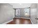 Bedroom featuring hardwood floors, light gray walls, and two bright windows at 121 Hamilton St, Henderson, NC 27536