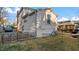 Charming home exterior with a well-maintained lawn, a picket fence, and lovely architectural details at 121 Hamilton St, Henderson, NC 27536