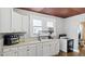 Bright kitchen with white cabinets, laminate countertop, and natural light at 121 Hamilton St, Henderson, NC 27536