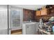 Functional laundry area with a washer, dryer, wood walls, and added storage at 121 Hamilton St, Henderson, NC 27536