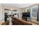 Spacious living room with hardwood floors, tv, access to the kitchen and natural light at 121 Hamilton St, Henderson, NC 27536
