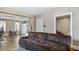 Comfortable living room featuring a plush sofa, neutral paint, and access to other rooms at 121 Hamilton St, Henderson, NC 27536
