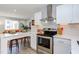 Modern kitchen featuring stainless steel oven, white cabinets, and breakfast bar seating at 1309 Hudson Ave # A14, Durham, NC 27705