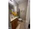 Bathroom with tile flooring, neutral wall color, decorative plants, toilet and sink at 1600 Buffaloe Rd, Garner, NC 27529