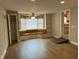 Living room featuring hardwood floors, a window bench, and a ceiling fan at 1600 Buffaloe Rd, Garner, NC 27529